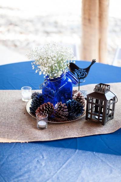 This lovely centerpiece with simple found objects like mason jars, laterns and re-purposed pine cones is truly one-of-a-kind! 